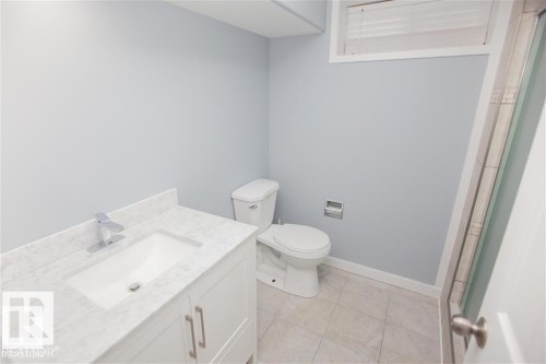 Bathroom with vanity, an enclosed shower, and light tile patterned floors - 17208 106 Street, Edmonton, AB - Indoor Photo Showing Bathroom