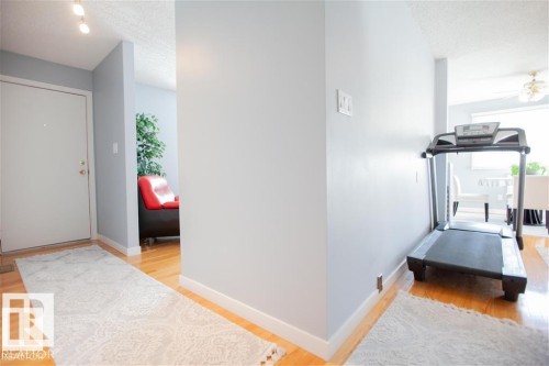 Hall with light wood-style flooring and a textured ceiling - 17208 106 Street, Edmonton, AB - Indoor Photo Showing Gym Room