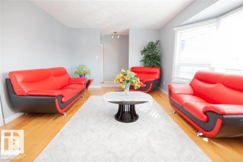 Living area with light wood finished floors and a textured ceiling - 17208 106 Street, Edmonton, AB - Indoor Photo Showing Living Room