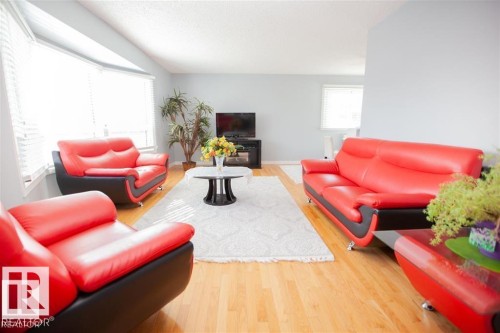 Living area featuring light wood-style floors and a textured ceiling - 17208 106 Street, Edmonton, AB - Indoor Photo Showing Living Room