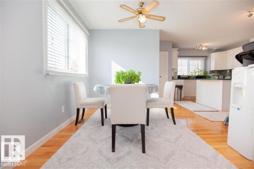 Dining space featuring light wood-style floors, a textured ceiling, and a ceiling fan - 17208 106 Street, Edmonton, AB - Indoor Photo Showing Dining Room
