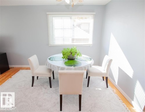 Dining space featuring light wood-style flooring and radiator - 17208 106 Street, Edmonton, AB - Indoor Photo Showing Dining Room