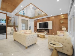 Living room featuring built in shelves, marble tiled flooring, recessed lighting, and a high ceiling - 