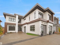 Contemporary house with a garage, stucco siding, and driveway - 