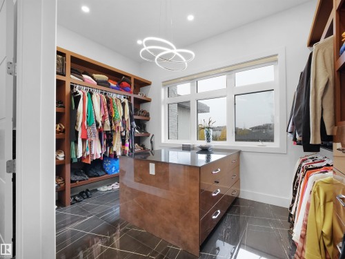 Walk in closet with suspended lighting - 4809 Woolsey Lane, Edmonton, AB - Indoor With Storage