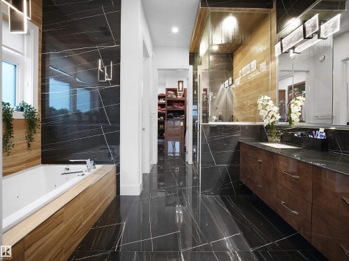 Bathroom featuring vanity, a whirlpool tub, tile walls, and recessed lighting - 4809 Woolsey Lane, Edmonton, AB - Indoor Photo Showing Bathroom