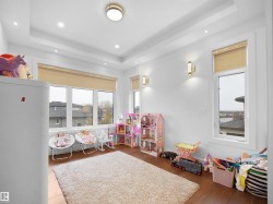 Game room with wood finished floors, a raised ceiling, and recessed lighting - 