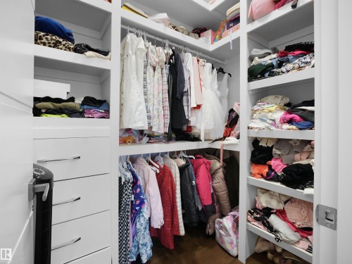 Walk in closet with dark wood-type flooring - 4809 Woolsey Lane, Edmonton, AB - Indoor With Storage