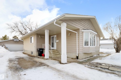 Bungalow with an outdoor structure, a detached garage, and a porch - 4423 18 Avenue, Edmonton, AB - Outdoor