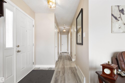 Hallway with light wood-style floors and a textured ceiling - 4423 18 Avenue, Edmonton, AB - Indoor Photo Showing Other Room