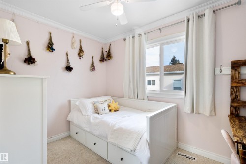 Bedroom featuring crown molding, light colored carpet, and ceiling fan - 4423 18 Avenue, Edmonton, AB - Indoor Photo Showing Bedroom