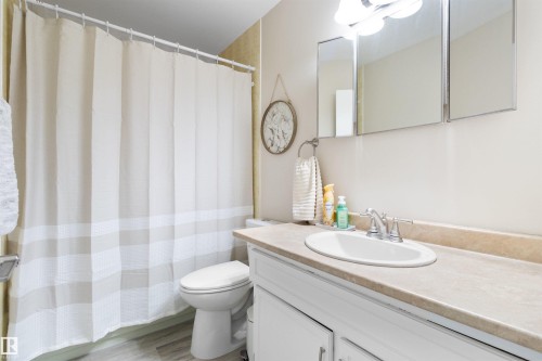 Full bath with vanity and light wood-style floors - 4423 18 Avenue, Edmonton, AB - Indoor Photo Showing Bathroom