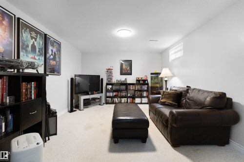 Living area featuring carpet floors and baseboards - 4423 18 Avenue, Edmonton, AB - Indoor