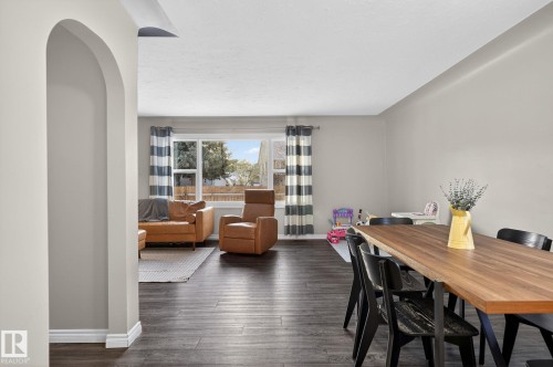 Dining space with dark wood-style flooring and arched walkways - 5 Langley Drive, Fort Saskatchewan, AB - Indoor