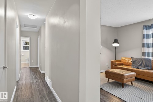 Hall with dark wood finished floors and baseboards - 5 Langley Drive, Fort Saskatchewan, AB - Indoor Photo Showing Other Room