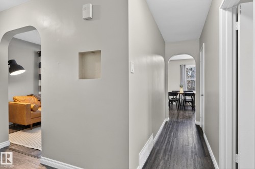 Hallway featuring arched walkways and dark wood-style floors - 5 Langley Drive, Fort Saskatchewan, AB - Indoor Photo Showing Other Room