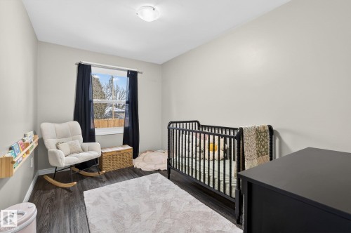 Bedroom with a nursery area and dark wood-type flooring - 5 Langley Drive, Fort Saskatchewan, AB - Indoor Photo Showing Bedroom