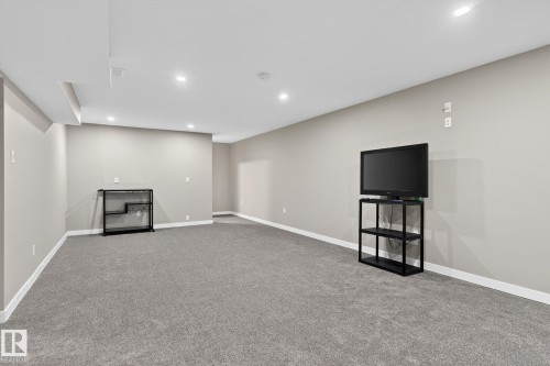 Finished below grade area with recessed lighting and light carpet - 5 Langley Drive, Fort Saskatchewan, AB - Indoor