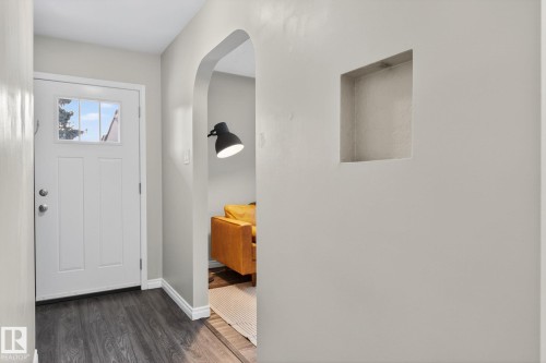 Foyer entrance with dark wood-style floors and arched walkways - 5 Langley Drive, Fort Saskatchewan, AB - Indoor Photo Showing Other Room