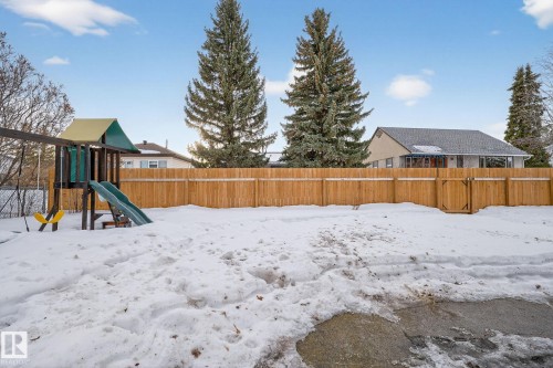 Snowy yard with a fenced backyard and a playground - 5 Langley Drive, Fort Saskatchewan, AB - Outdoor