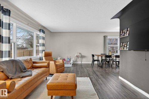 Living room featuring dark wood finished floors and healthy amount of natural light - 5 Langley Drive, Fort Saskatchewan, AB - Indoor Photo Showing Living Room