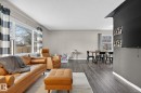 Living room featuring dark wood finished floors and healthy amount of natural light - 5 Langley Drive, Fort Saskatchewan, AB  - Indoor Photo Showing Living Room 