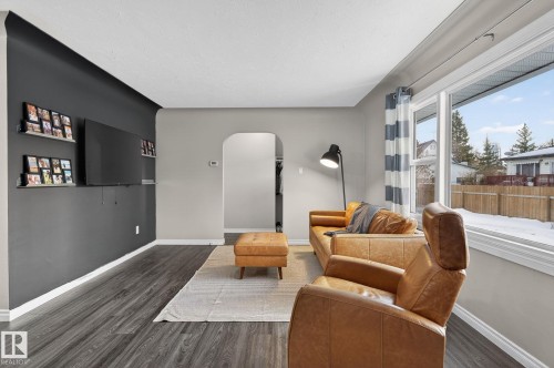 Living area with arched walkways and wood finished floors - 5 Langley Drive, Fort Saskatchewan, AB - Indoor