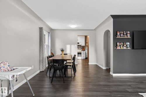 Dining room featuring arched walkways and dark wood-style flooring - 5 Langley Drive, Fort Saskatchewan, AB - Indoor Photo Showing Dining Room