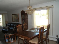 Dining space featuring ornamental molding, a textured ceiling, a chandelier, and tile patterned flooring - 