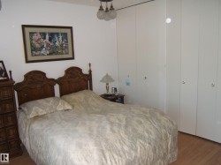 Bedroom featuring wood finished floors and a closet - 