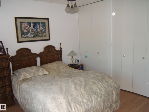 Bedroom featuring wood finished floors and a closet - 4807 54 Avenue, Two Hills, AB - Indoor Photo Showing Bedroom