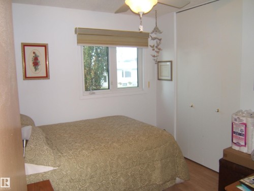 Bedroom featuring wood finished floors and a closet - 4807 54 Avenue, Two Hills, AB - Indoor Photo Showing Bedroom