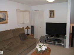 Carpeted living room featuring a textured ceiling - 