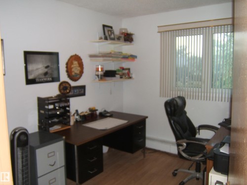 Office space with wood finished floors and a baseboard heating unit - 4807 54 Avenue, Two Hills, AB - Indoor Photo Showing Office