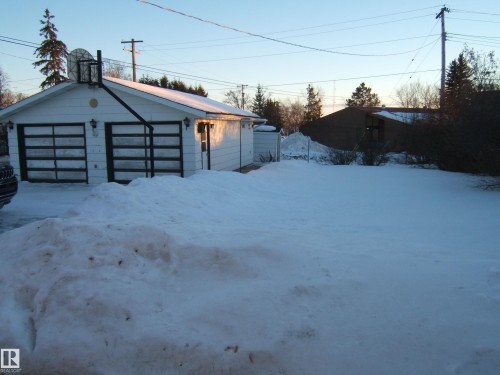 Snow covered garage with a garage - 4807 54 Avenue, Two Hills, AB - Outdoor