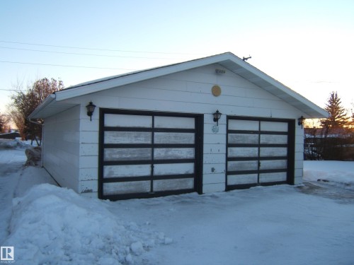 Snow covered garage with a garage - 4807 54 Avenue, Two Hills, AB - Outdoor