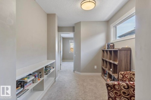 Sitting room with light carpet and a textured ceiling - 21703 86 Avenue, Edmonton, AB - Indoor Photo Showing Other Room