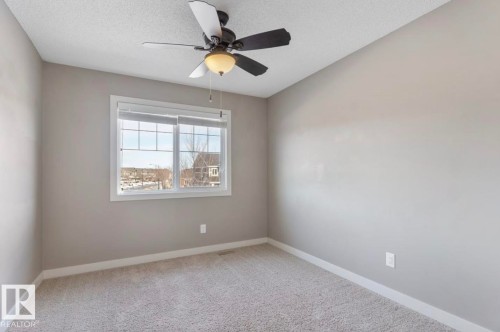 Unfurnished room with light carpet, ceiling fan, and a textured ceiling - 21703 86 Avenue, Edmonton, AB - Indoor Photo Showing Other Room