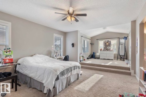 Bedroom with carpet floors, a textured ceiling, and ceiling fan - 21703 86 Avenue, Edmonton, AB - Indoor Photo Showing Bedroom