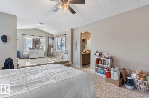 Bedroom featuring carpet flooring, a ceiling fan, and connected bathroom - 21703 86 Avenue, Edmonton, AB - Indoor Photo Showing Bedroom