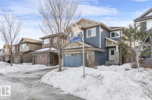 Craftsman-style home featuring stone siding and a garage - 21703 86 Avenue, Edmonton, AB - Outdoor With Facade