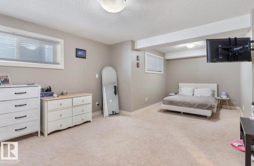 Bedroom featuring light carpet and a textured ceiling - 21703 86 Avenue, Edmonton, AB - Indoor Photo Showing Bedroom