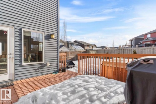 Wooden deck featuring a residential view, a fenced backyard, and grilling area - 21703 86 Avenue, Edmonton, AB - Outdoor With Deck Patio Veranda
