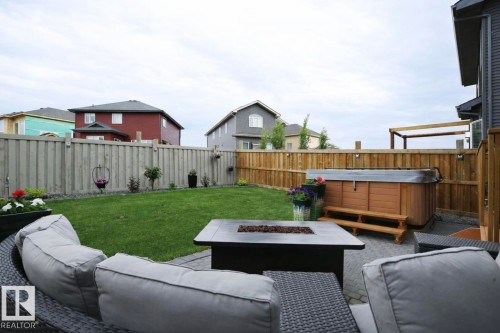 Fenced backyard featuring a patio, an outdoor living space with a fire pit, and a hot tub - 21703 86 Avenue, Edmonton, AB - Outdoor With Deck Patio Veranda