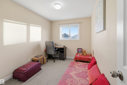 Bedroom featuring light carpet and an office area - 8 230 Edwards Drive, Edmonton, AB - Indoor