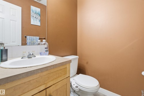 Half bathroom with toilet and vanity - 8 230 Edwards Drive, Edmonton, AB - Indoor Photo Showing Bathroom