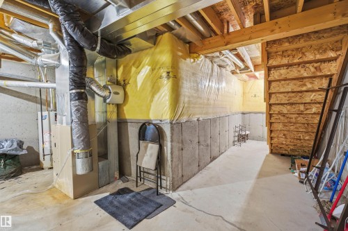 Unfinished basement with heating unit and water heater - 8 230 Edwards Drive, Edmonton, AB - Indoor Photo Showing Basement