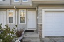 Doorway to property with a garage and stone siding - 8 230 Edwards Drive, Edmonton, AB  - Outdoor With Exterior 
