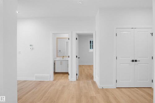 Hallway with light wood finished floors and baseboards - 6228 29 Avenue, Edmonton, AB - Indoor Photo Showing Other Room