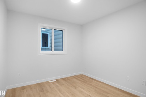 Spare room featuring baseboards and light wood-style floors - 6228 29 Avenue, Edmonton, AB - Indoor Photo Showing Other Room